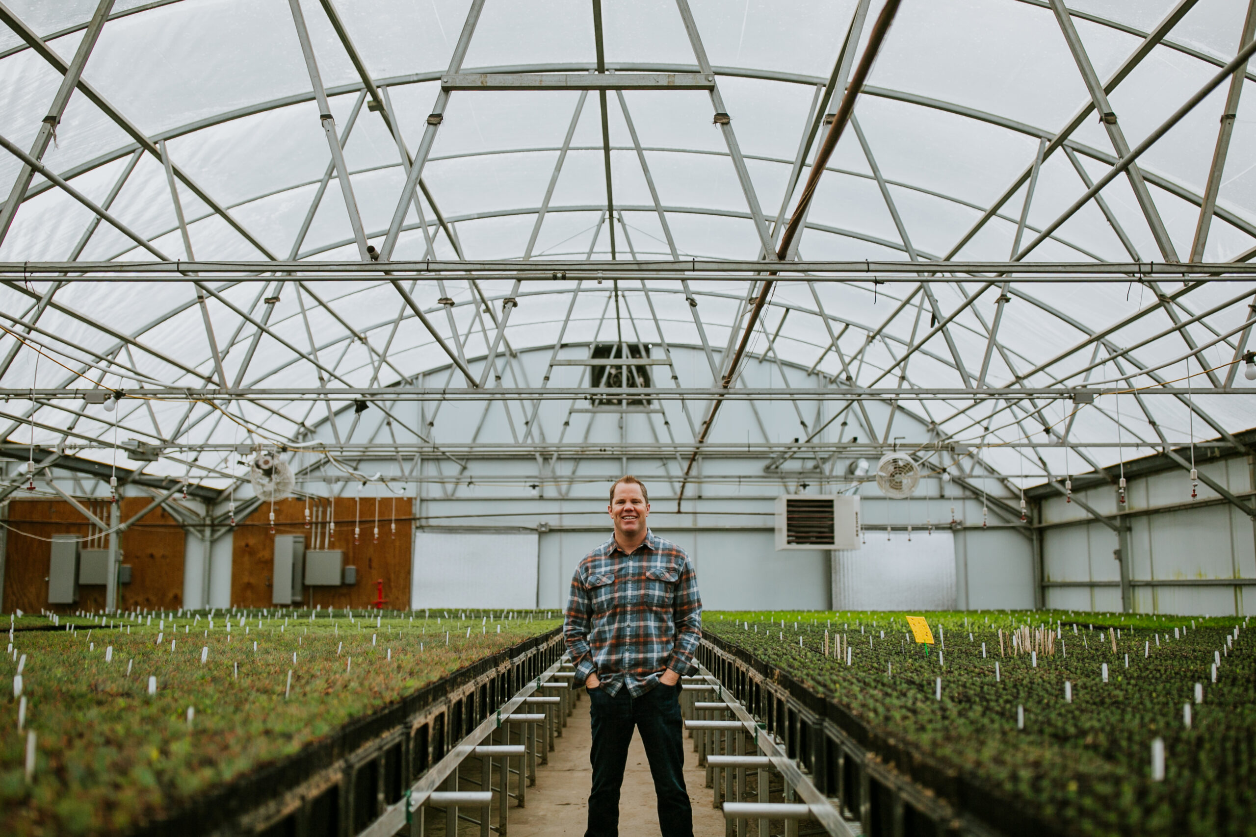 Kevin Brinkman, founder of OneCanopy, stands in the greenhouse in Loveland.